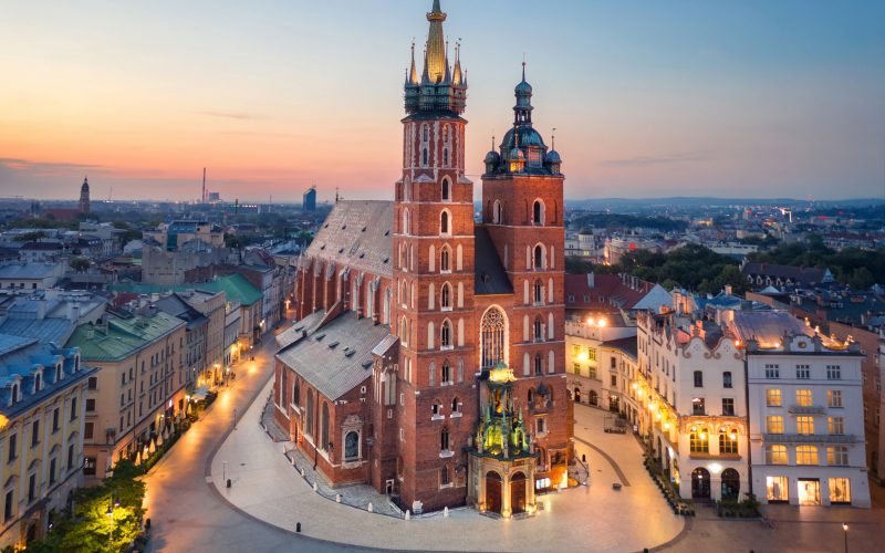 Krakow, Poland. Aerial view of illuminated St. Mary's Basilica (Bazylika Mariacka) on sunrise