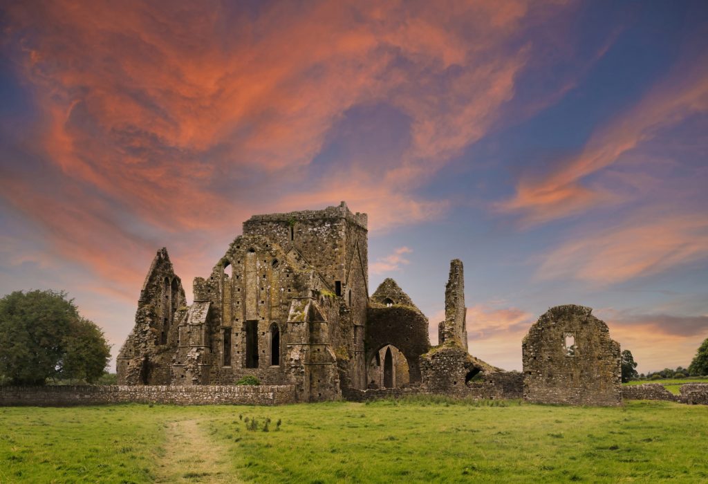 Ruins of Hore Abbey at sunset with reddish clouds, near the Irish village of Cashel. Built by Benedictine monks in the 13th century.